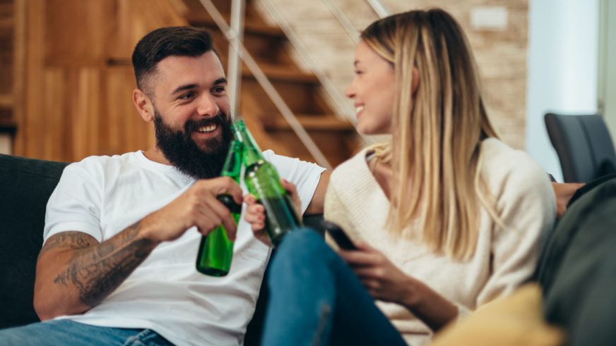 Couple drinking beer at home