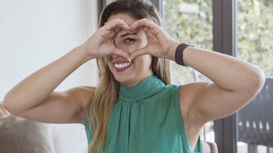 Brazilian woman making hands in heart shape, life insurance, donation, happy volunteer concept