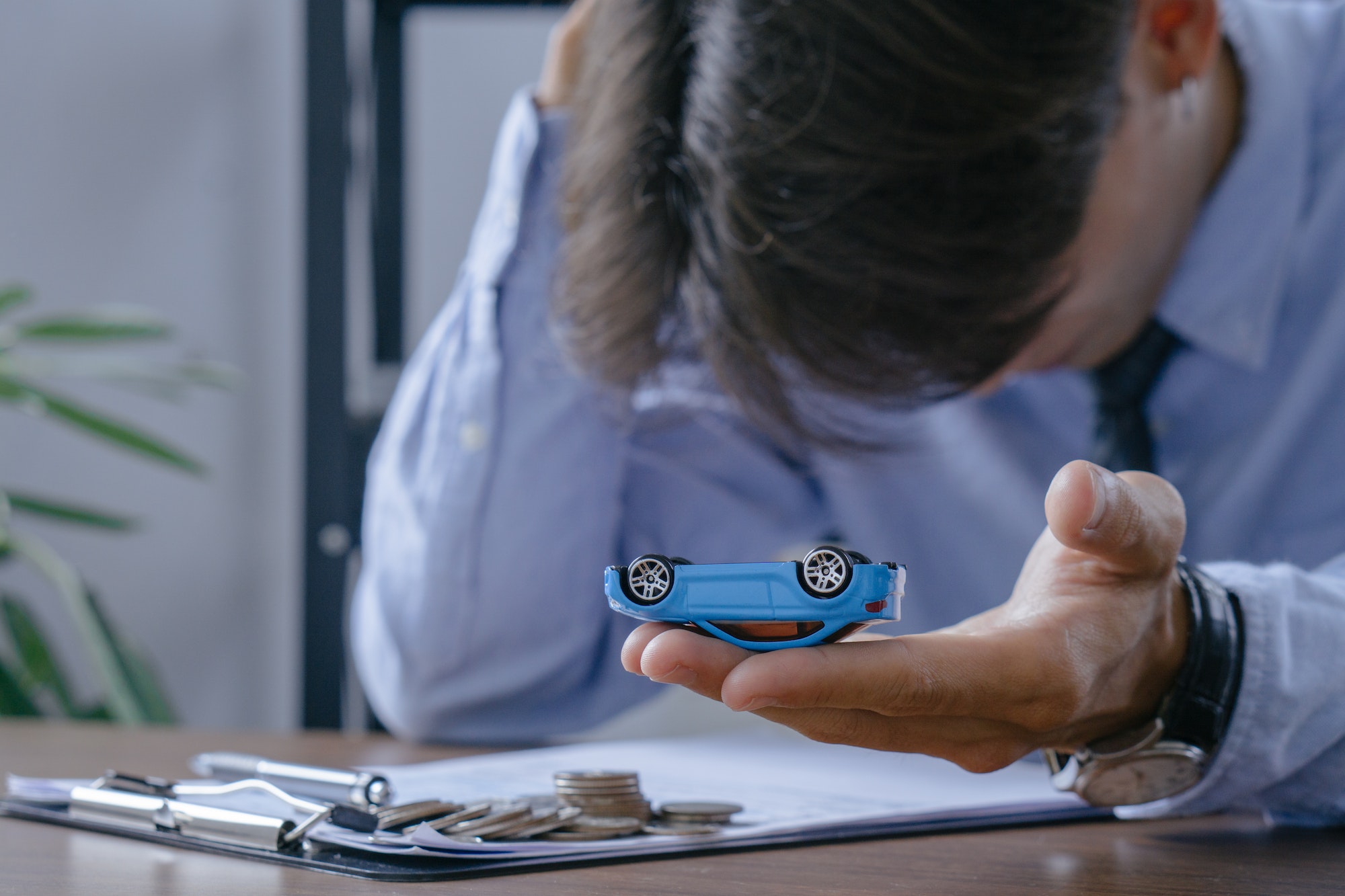 Car insurance concept.Insurance officer stressed while inspecting car damages.