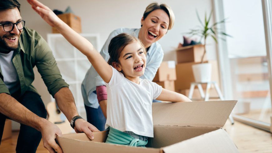 Cheerful family having fun while moving into their new home.
