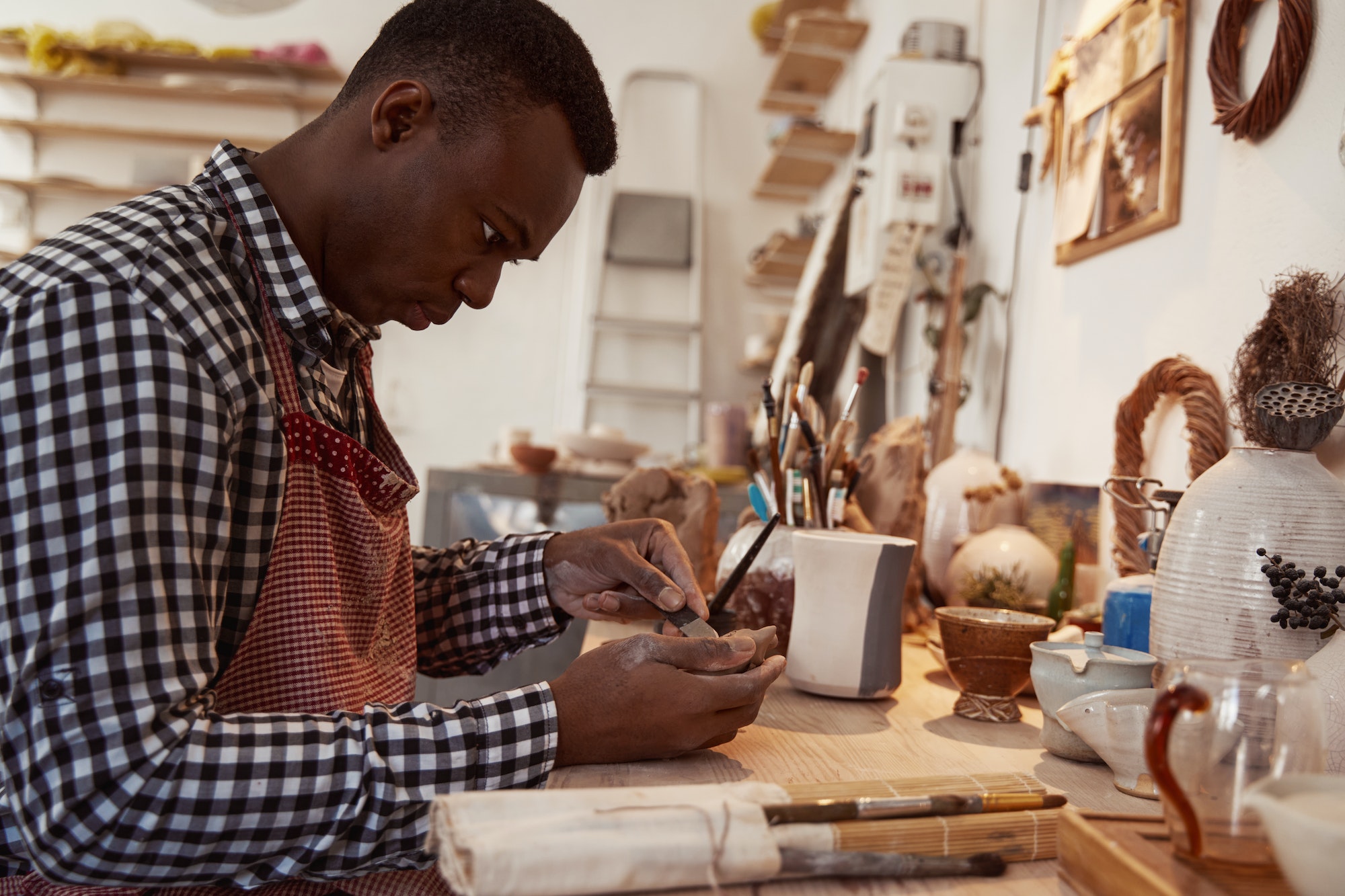 Concentrated ceramic artist crafting piece of pottery