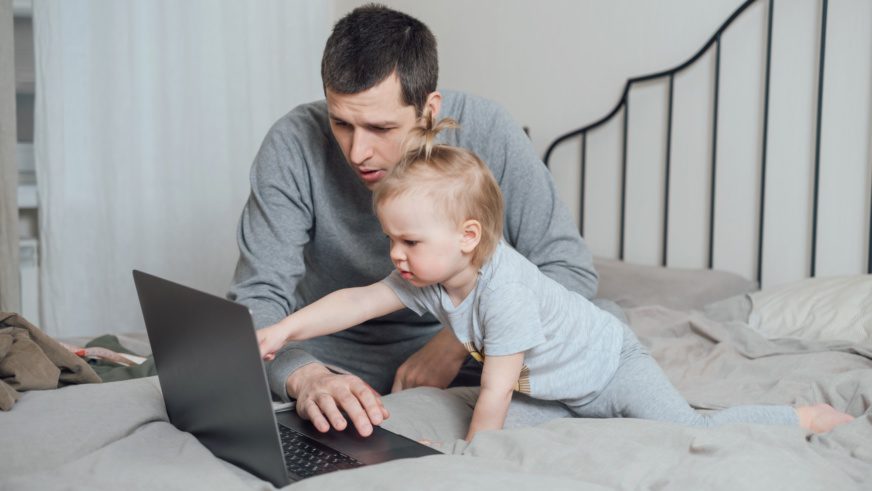 Dad and daughter choose something on the Internet through a computer