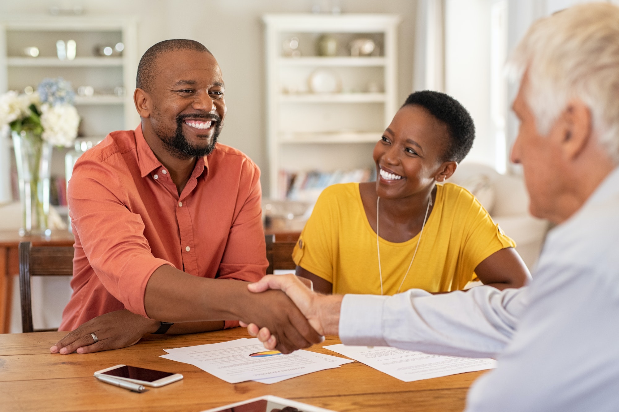 Man shaking hands with insurance agent