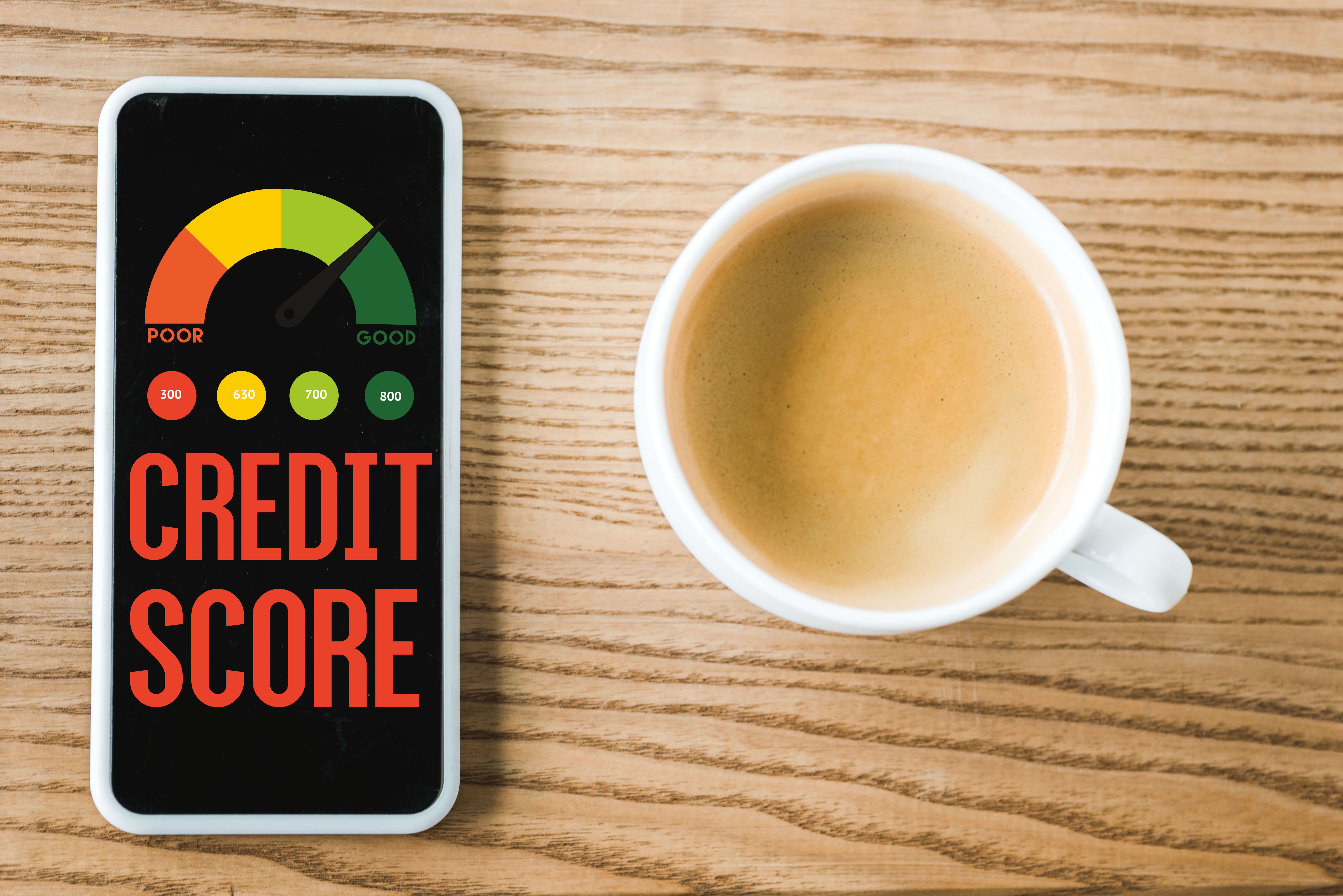 top view of smartphone with credit score lettering on screen near cup of coffee on table